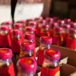 Une bouteille de sauce d'huître brune posée près d'un wok