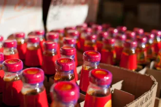 Une bouteille de sauce d'huître brune posée près d'un wok